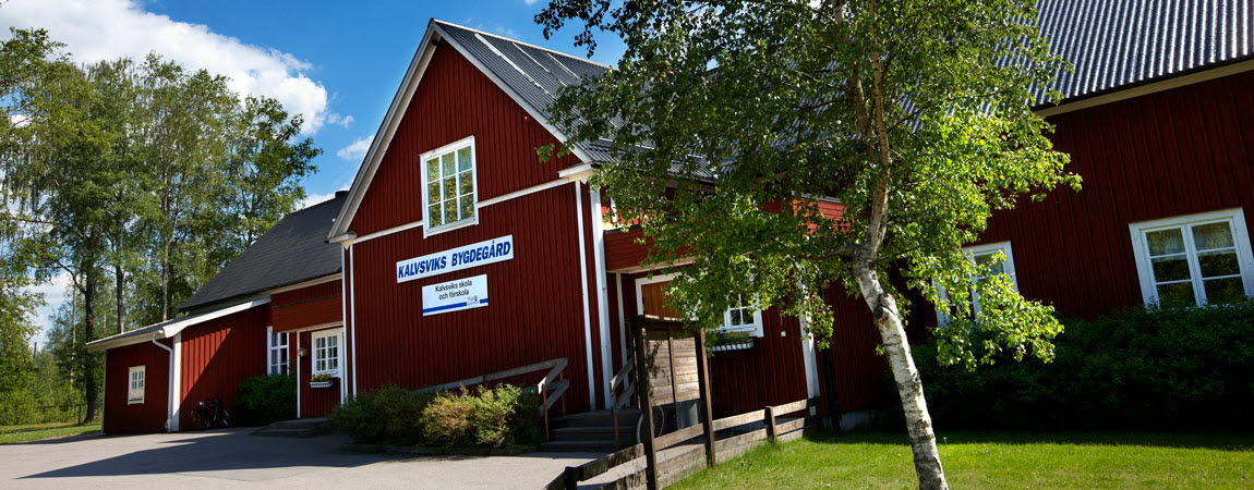 Röd trähusbyggnad på fasaden står det Kalviks skola och förskola.